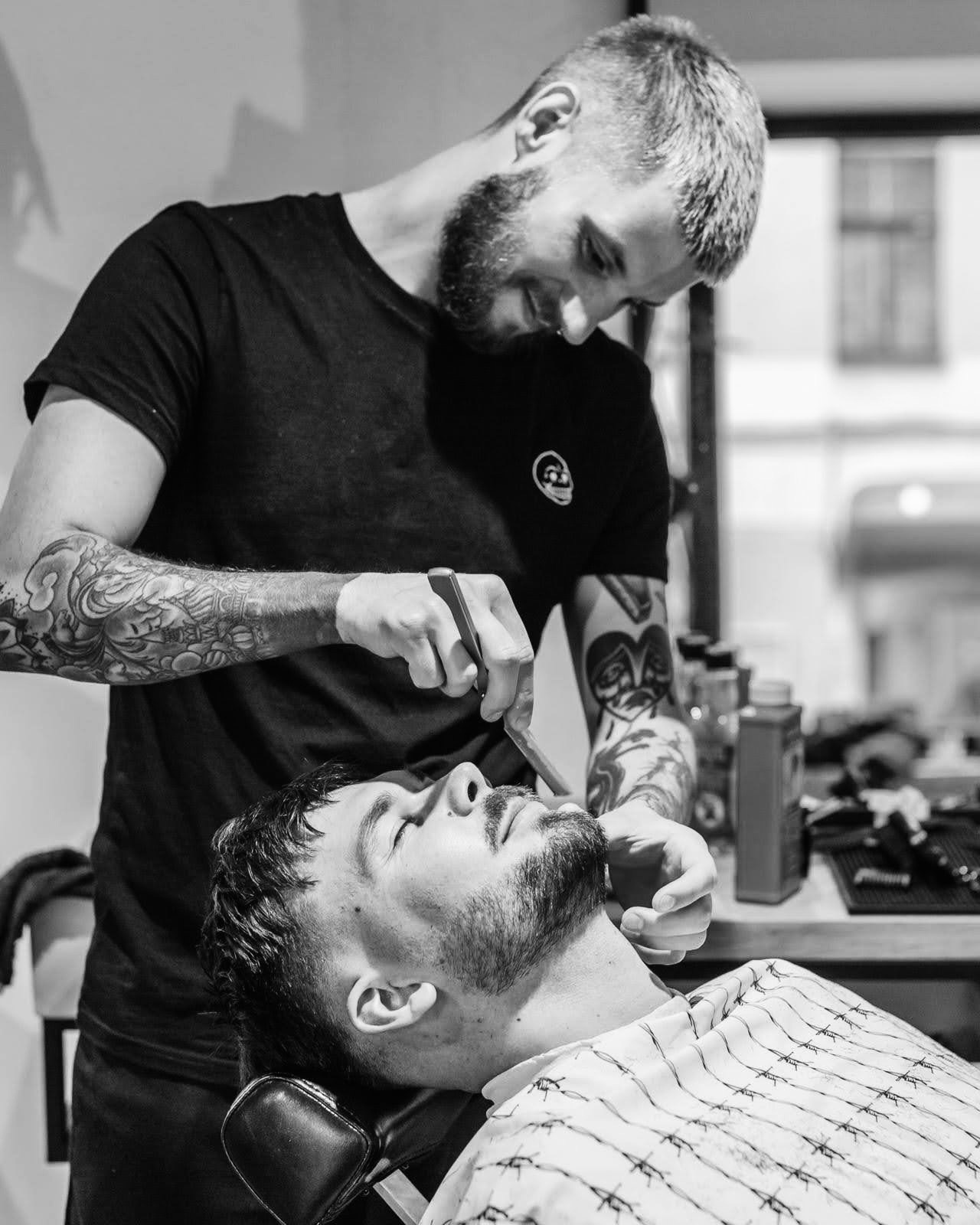 Barber working with a client